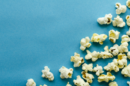 popcorn on blue paper backgroundの写真素材