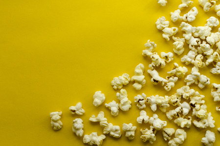 popcorn  on yellow paper backgroundの写真素材