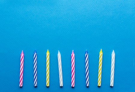  multicolored candles for cake on paper backgroundの写真素材