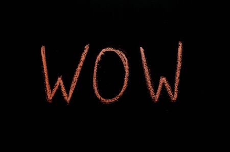 chalk drawn wow on blackboardの写真素材