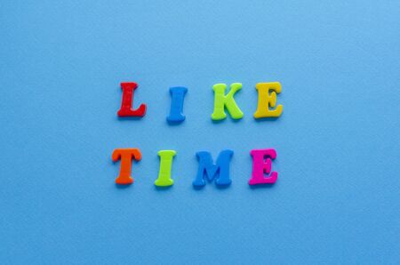 words "liketime" from plastic letters on paper backgroundの写真素材