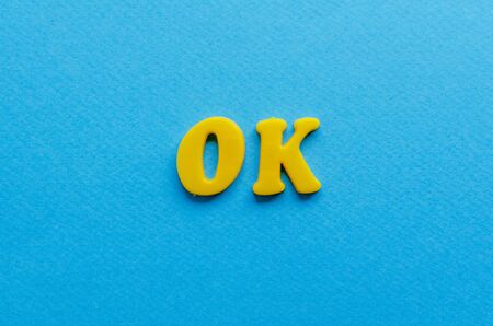 ok from plastic magnets on paper backgroundの写真素材