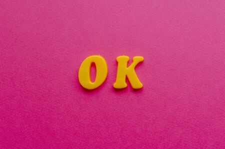 ok from plastic magnets on paper backgroundの写真素材