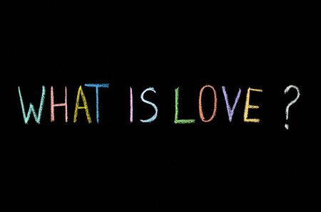 "what is love?" drawn on chalkboardの写真素材