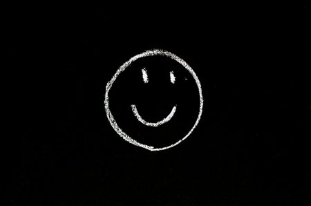 smiling face drawn on chalkboardの写真素材