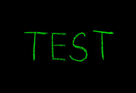 colored text test drawn on blackboardの写真素材