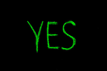 colored text yes drawn on blackboardの写真素材