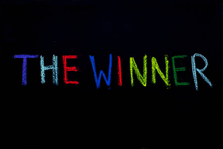colored text the winner  drawn on blackboardの写真素材