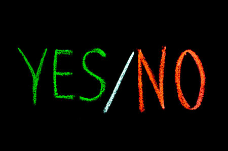colored text yes or no drawn on blackboardの写真素材