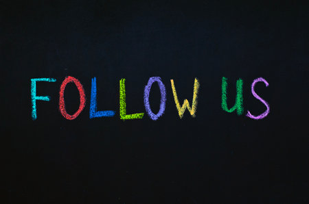 colored text follow us drawn on blackboardの写真素材