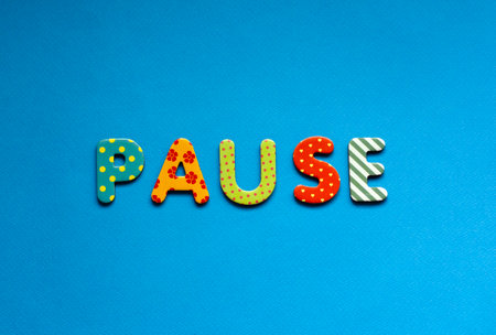 color text pause on blue paper backgroundの写真素材