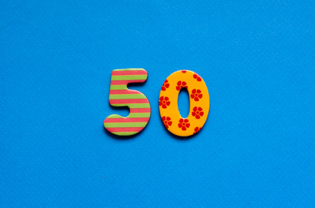 fifty on blue paper backgroundの写真素材