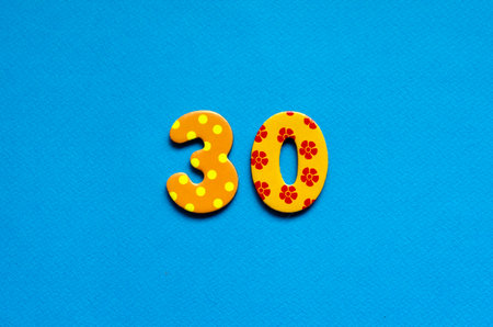 numeric thirty on blue paper backgroundの写真素材