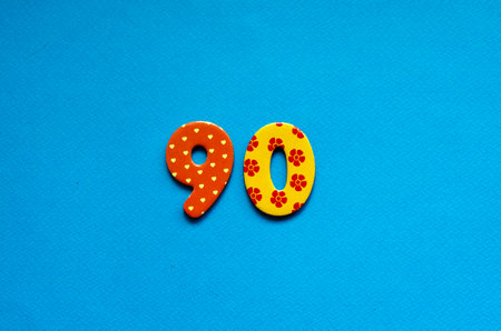 ninety on blue paper backgroundの写真素材