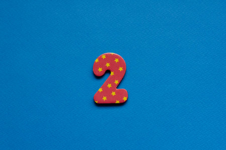 number two on blue paper background