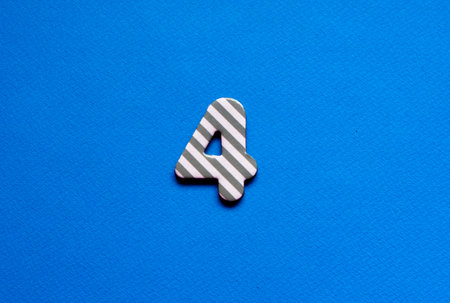 number four on blue paper backgroundの写真素材