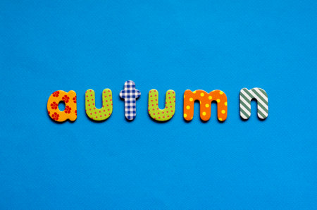 word autumn on blue paper backgroundの写真素材