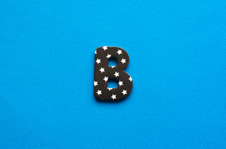 letter b on blue paper backgroundの写真素材