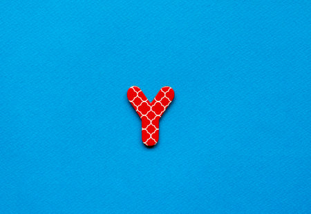 letter y on blue paper backgroundの写真素材