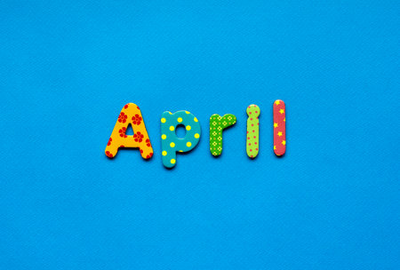 colored text April on blue paper backgroundの写真素材