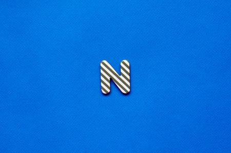 letter n on blue paper backgroundの写真素材