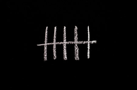 crossed sticks on the chalkboardの写真素材