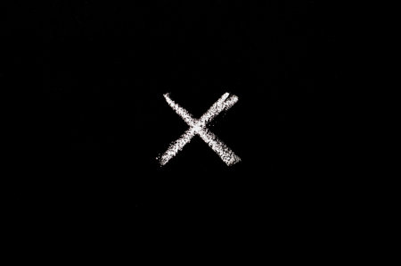 symbol cross drawn on blackboardの写真素材