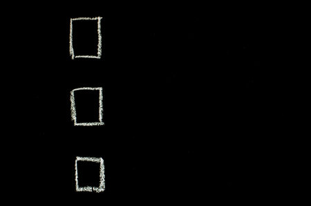 white checkboxes drawn on blackboardの写真素材