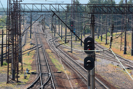 Tangled electrical wires, rails and switches at railroad junction station