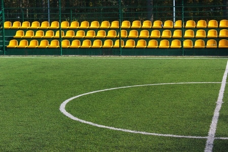 Empty yellow seats at mini soccer stadiumの写真素材