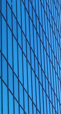Blue glass facade of office building perspective view