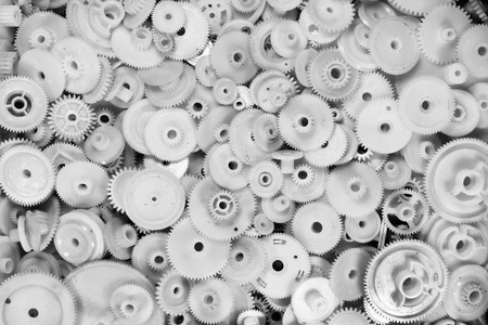 White plastic gears and cogwheels as a backgroundの写真素材