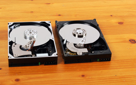 two open hard drives on wooden background