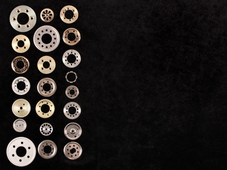 Shiny aluminum spacers and washers on black velvet background