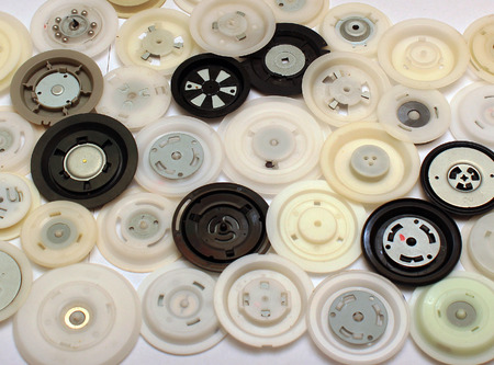 Many round plastic clamps from cd and dvd disc drivesの写真素材