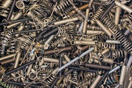 Many small metal coils and springs as a backgroundの写真素材