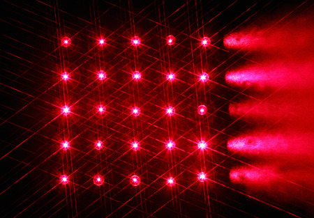 Array of red semiconductor lasers in the darkの写真素材