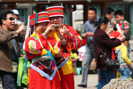 SHILIN, CHINA - MARCH 7, 2012: Two women tour guides dressed in traditional Sani costumes. The Sani is a small ethnic group from Yi minority of Southern China.のeditorial素材