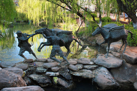 LIJIANG, CHINA, MARCH 11, 2012: Statue depicting tea caravans of the Ancient Southern Silk Road, or Ancient Tea and Horse Road. Lijiang was the most important place of Ancient tea route, which went from Burma to Mediterranean Sea.のeditorial素材