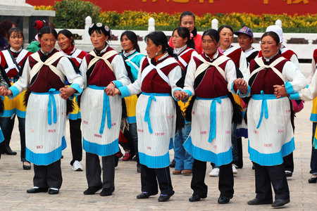 LIJIANG, CHINA, MARCH 8, 2012: Naxi women in traditional costumes dancing at Old Town of Lijiang. Naxi is ethnic minority group living in the northwestern part of chinese Yunnan Province.のeditorial素材