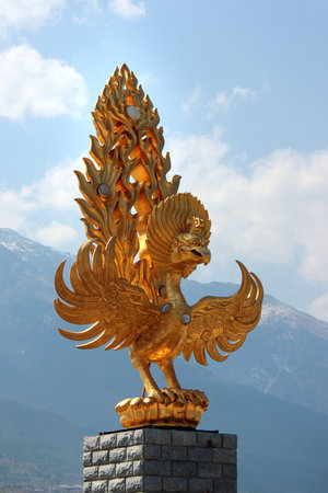 DALI, CHINA - MARCH 13, 2012: Statue of Golden Phoenix in front of famous Chongsheng Temple with Three Pagodas in Dali, Yunnan is a popular tourist destination.のeditorial素材