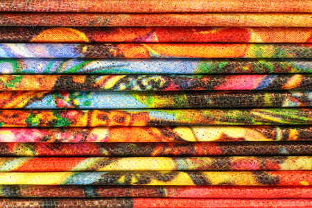 Stack of colorful folded capron cloth. Horizontal layers of reticulated fabric background.の写真素材