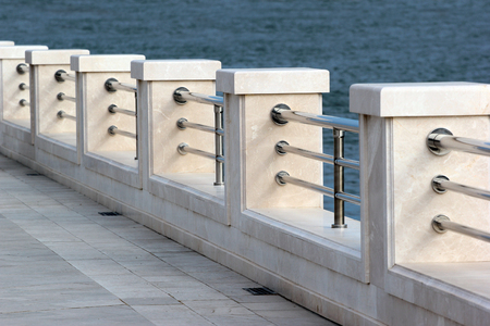 Marble metal fence on empty seafront promenadeの写真素材