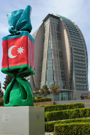 BAKU, AZERBAIJAN - APRIL 28, 2017: Trump Tower unfinished 5-star hotel and sculpture "Azerbaijan" by Laurence Jenkell, French artist and sculptor, 2013のeditorial素材