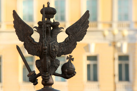 SAINT PETERSBURG, RUSSIA - JULY 4, 2017: Silhouette of bronze double-headed eagle with sword, orb and cross. Symbol and coat of arms of Russia. Fragment of fence around the Alexander Column on Palace Square.のeditorial素材