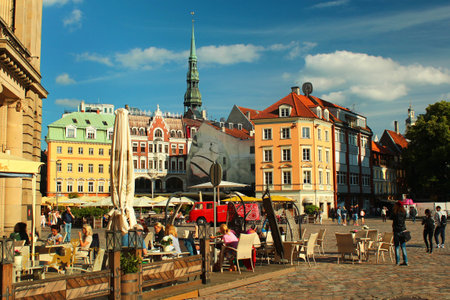 RIGA, LATVIA - JULY 10, 2017: Street cafe on the Dome Square in the Old Town of Riga, UNESCO World Heritage Site and popular tourist destination.のeditorial素材