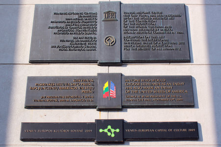 VILNIUS, LITHUANIA - JULY 13, 2017: Sign plates on Vilnius Town Hall building, confirming that Vilnius Old Town is listed as UNESCO World Heritage Site and proclaiming friendship between Lithuania and USA.のeditorial素材