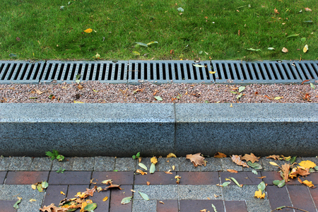 Kerbside and rainwater drainage system in a parkの写真素材