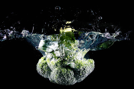 Cauliflower falling into water, isolated against black backgroundの写真素材