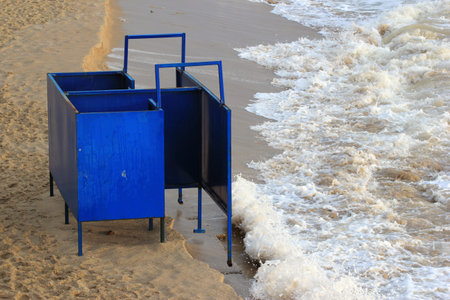 Old metal changing hut on a beachの写真素材
